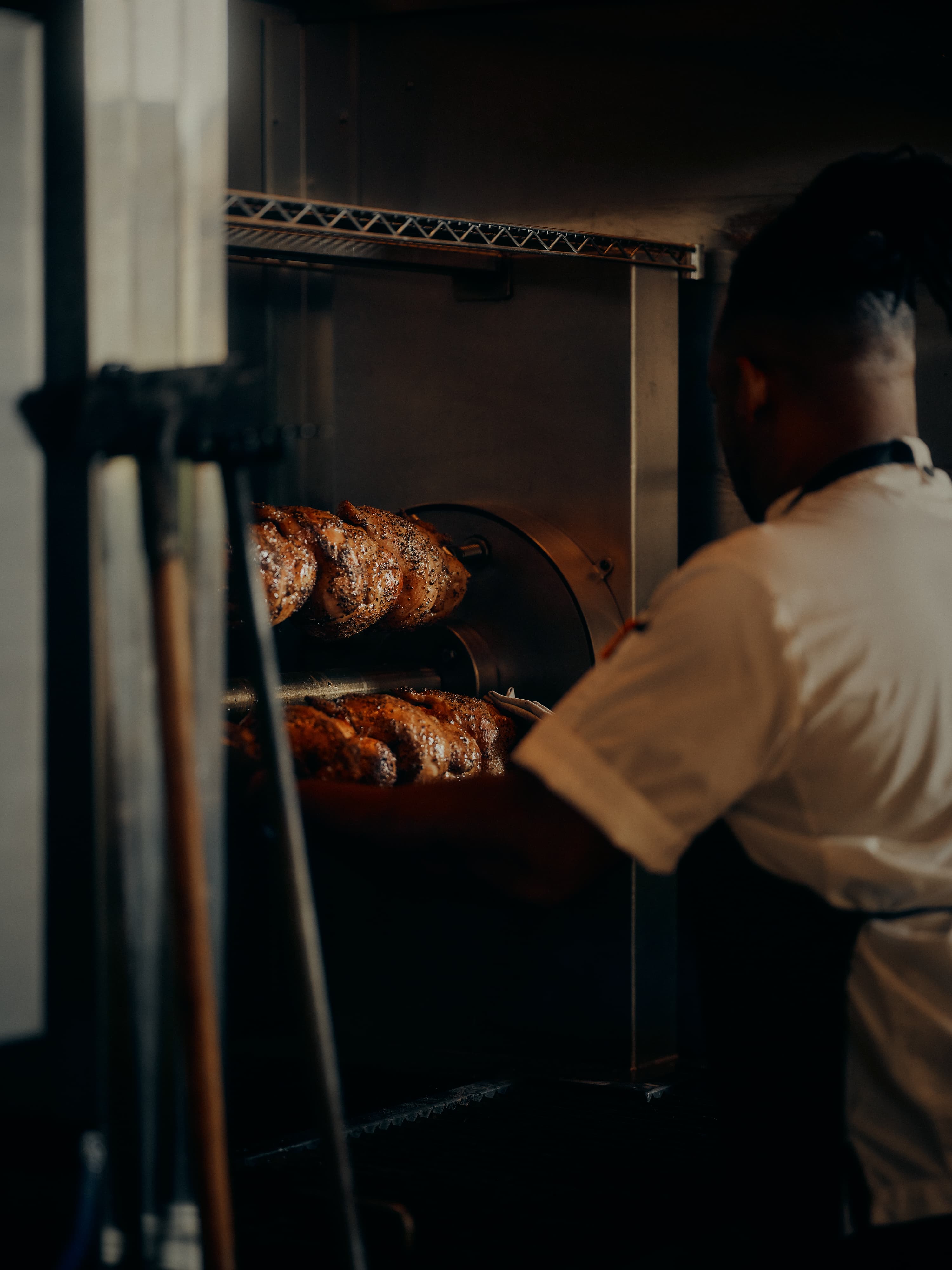 Chickens turning on the rotisserie at the wood-fired hearth