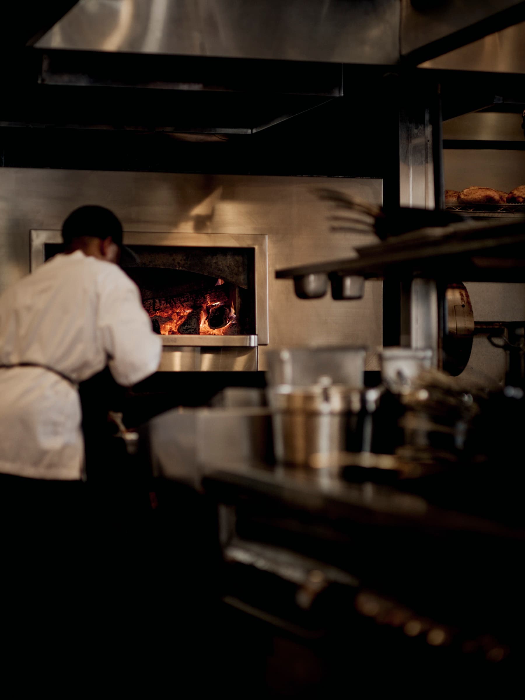 The rotisserie turning at the wood-fired oven
