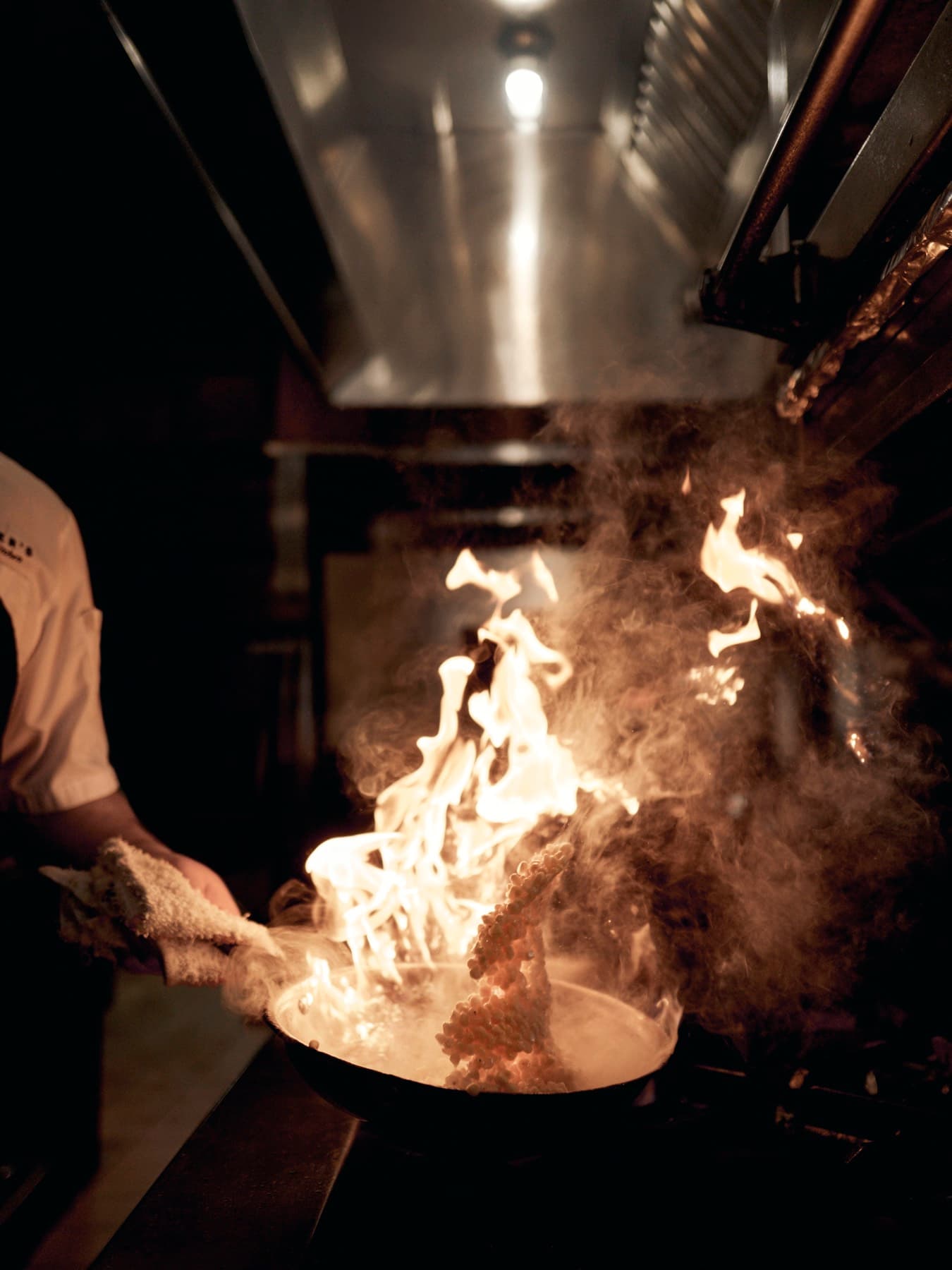 Flames leaping from a sauté pan in the SouthPark kitchen
