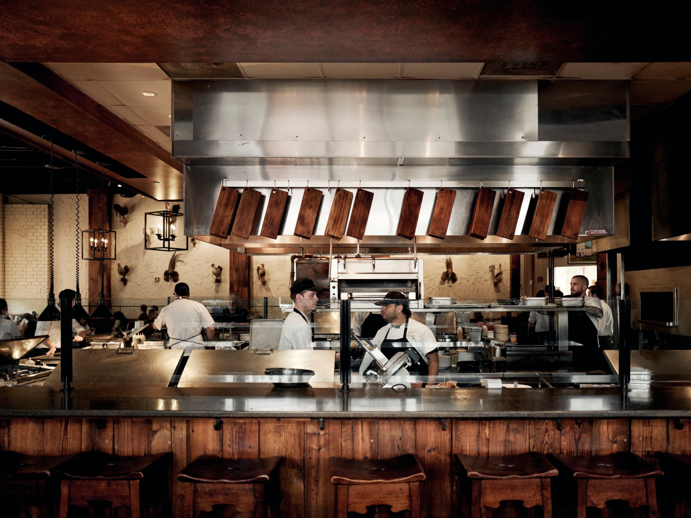 The open kitchen at Rooster's SouthPark, cooks at the pass