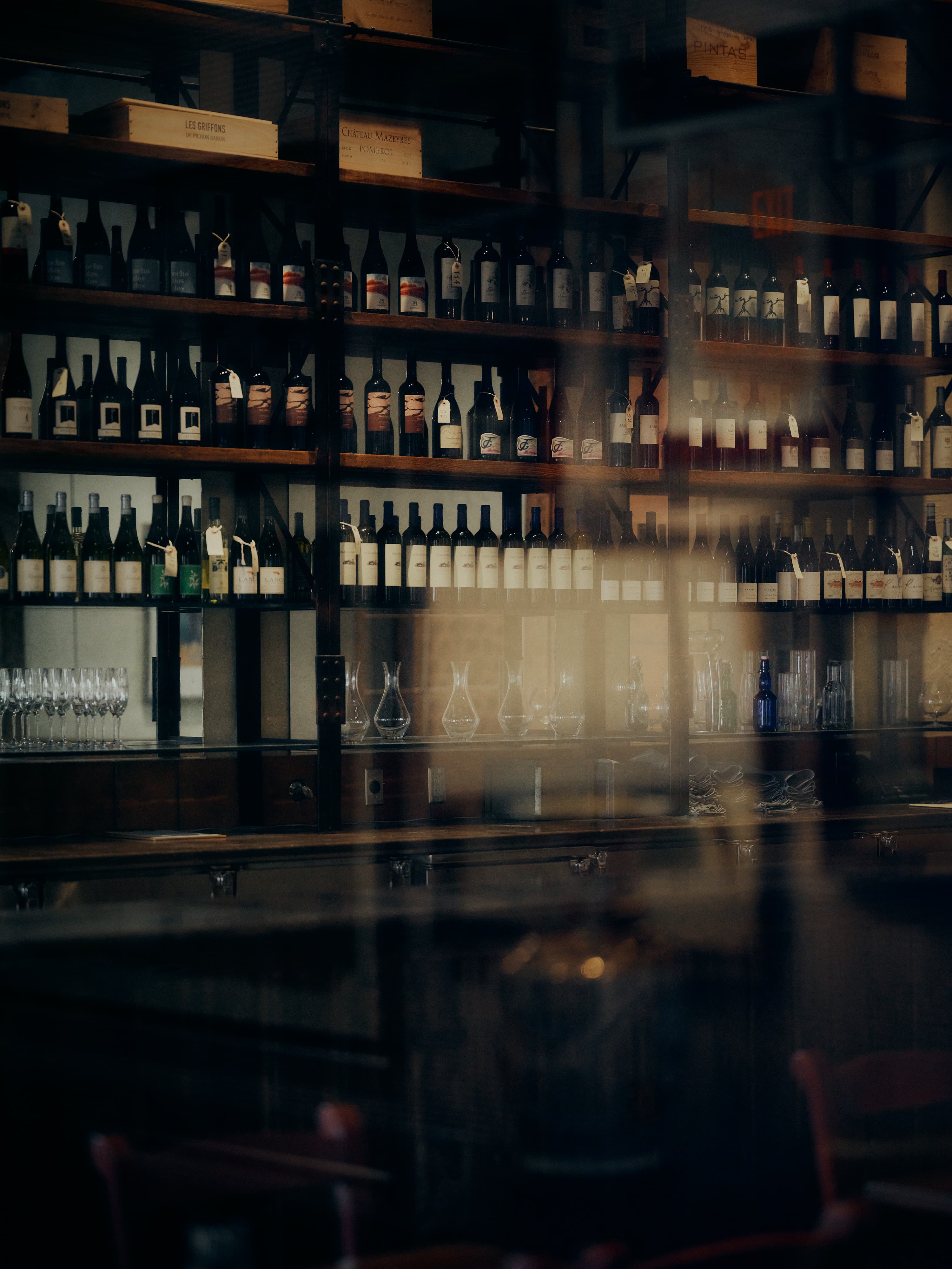 The wine wall at Rooster's, bottles stacked to the ceiling